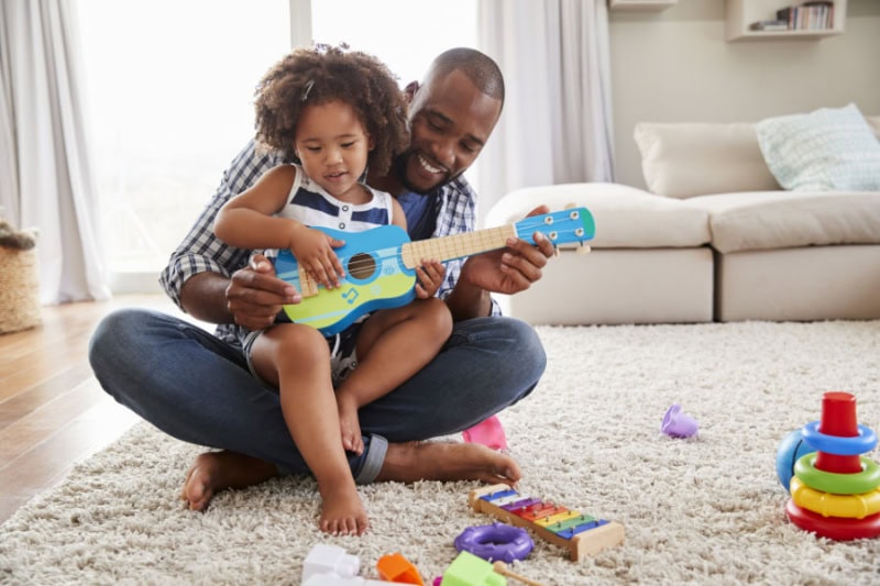 dad and toddler playing together.