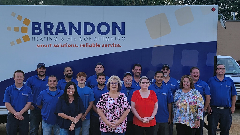 The Brandon Heating & Air Conditioning team in front of their truck outside.