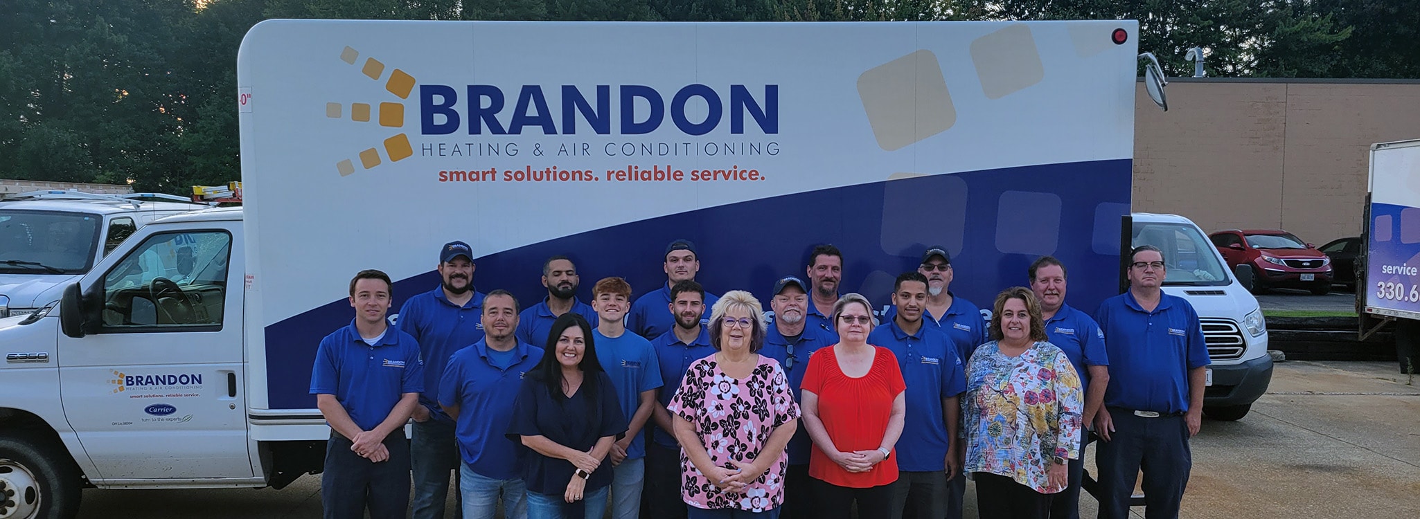 The Brandon Heating & Air Conditioning team in front of their truck outside.